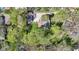 Aerial view of a home nestled among lush trees with a driveway and backyard deck visible at 8190 Jordan Ln, Indianapolis, IN 46240