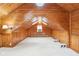 Spacious finished attic with wood walls, carpet, and a skylight at 8190 Jordan Ln, Indianapolis, IN 46240