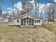 Charming back view of the home with a screened in porch and well-manicured yard at 8190 Jordan Ln, Indianapolis, IN 46240