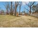Large grassy backyard with partial fence and mature trees plus playground at 8190 Jordan Ln, Indianapolis, IN 46240