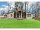 This home features a lovely screened-in porch and a well-manicured lawn at 8190 Jordan Ln, Indianapolis, IN 46240