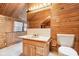Bathroom with wood paneling, bright lighting, and a sink at 8190 Jordan Ln, Indianapolis, IN 46240