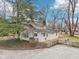 Home featuring a lovely backyard with mature trees, wooden deck, and well-maintained landscaping at 8190 Jordan Ln, Indianapolis, IN 46240