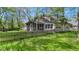Charming home with a screened porch and a white picket fence surrounded by mature trees and a green lawn at 8190 Jordan Ln, Indianapolis, IN 46240
