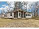 Home exterior with screened in porch and backyard with partial fence and mature trees at 8190 Jordan Ln, Indianapolis, IN 46240