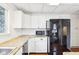 Well-lit kitchen with stainless steel appliances, ample cabinet space, and wood flooring offers modern convenience and storage at 8190 Jordan Ln, Indianapolis, IN 46240