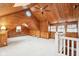Bright living room featuring wood-paneled walls, skylights, and a ceiling fan at 8190 Jordan Ln, Indianapolis, IN 46240