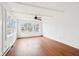 Bright, spacious living room with wood floors, white walls and large windows offering ample natural light and space at 8190 Jordan Ln, Indianapolis, IN 46240