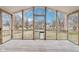 Enclosed porch with wood floors featuring screens and dog door leading to fenced backyard at 8190 Jordan Ln, Indianapolis, IN 46240