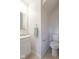 A small bathroom with a toilet, sink, mirror, towel rack, and base trim at 8444 Ash Grove Dr, Camby, IN 46113