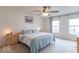 Large bedroom with a ceiling fan, carpeted floor, neutral walls, and two large windows at 8444 Ash Grove Dr, Camby, IN 46113