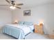 Bright bedroom features a ceiling fan, light blue bedding, and wooden nightstands at 8444 Ash Grove Dr, Camby, IN 46113