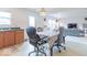 Bright dining room with ample lighting, an adjacent living room, and a door leading outside at 8444 Ash Grove Dr, Camby, IN 46113