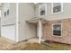 Inviting entrance to a two-story home featuring a covered porch and brick accents at 8444 Ash Grove Dr, Camby, IN 46113
