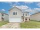 Charming two-story home featuring a front-facing garage and a neatly maintained lawn at 8444 Ash Grove Dr, Camby, IN 46113