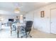 Living room with an adjacent dining area, gray couch, large TV, and neutral colored walls at 8444 Ash Grove Dr, Camby, IN 46113