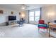 Bright living room with a ceiling fan, carpeted floors, and plenty of natural light from the windows at 8444 Ash Grove Dr, Camby, IN 46113