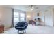 Bright loft with ceiling fan, carpeted floors, windows with curtains, and a comfortable blue chair at 8444 Ash Grove Dr, Camby, IN 46113