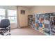 Home office features a large bookcase, a rolling office chair and a window at 8444 Ash Grove Dr, Camby, IN 46113