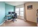 Home office features a dual monitor setup, a rolling office chair and a window at 8444 Ash Grove Dr, Camby, IN 46113