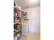 Pantry features a standalone freezer, wire racks with food supplies, and vinyl flooring at 8444 Ash Grove Dr, Camby, IN 46113
