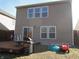 Backyard view showcases wood deck, grill, and rear siding of house with sliding doors at 8848 Hosta Way, Camby, IN 46113