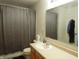 Bathroom with shower and gray curtain, bright single sink vanity, and white cabinets at 8848 Hosta Way, Camby, IN 46113