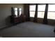 A minimalist bedroom featuring dark curtains, dresser, carpet flooring, and natural light at 8848 Hosta Way, Camby, IN 46113