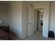 Neutral paint, carpeted bedroom shows a large window and view into a connecting room at 8848 Hosta Way, Camby, IN 46113