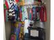 Organized closet featuring colorful clothing and storage containers at 8848 Hosta Way, Camby, IN 46113
