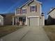 Inviting two-story home with neutral siding, red shutters, well-maintained landscaping, and attached garage at 8848 Hosta Way, Camby, IN 46113