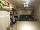 The garage has ample storage on white shelves and a modern tan car parked inside at 8848 Hosta Way, Camby, IN 46113