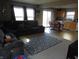 Bright living area with sliding glass doors to the rear, open to the kitchen and dining space at 8848 Hosta Way, Camby, IN 46113