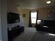 View of the living room with wall-mounted TV, plush seating, and bright natural light at 8848 Hosta Way, Camby, IN 46113