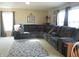 Comfortable living room with plush sectional sofa, patterned rug, and bright natural lighting at 8848 Hosta Way, Camby, IN 46113
