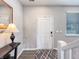 Bright foyer featuring wood floors, a white front door, a table with lamp and a stairwell at 9034 Faulkner Dr, Indianapolis, IN 46239