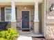 Close-up of the front door with a wreath, brick columns, and a 'hello' welcome mat at 9034 Faulkner Dr, Indianapolis, IN 46239