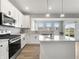 Bright kitchen with white cabinets, stainless steel appliances, and quartz countertops at 9034 Faulkner Dr, Indianapolis, IN 46239