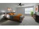 Relaxing main bedroom with a ceiling fan, large window, and neutral decor at 9034 Faulkner Dr, Indianapolis, IN 46239