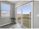 Patio view through a glass door showing outdoor space with a grassy area and neighborhood at 9034 Faulkner Dr, Indianapolis, IN 46239
