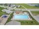 Aerial view of a community pool with lounge chairs, a hot tub, and nearby playground, offering recreational amenities at 9034 Faulkner Dr, Indianapolis, IN 46239