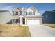 Inviting two-story home showcasing a well-manicured lawn and attached two-car garage at 10202 Meadow Path Ln, Indianapolis, IN 46239