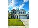 Charming two-story home with a well-manicured lawn, gray brick and gray siding, a 2-car garage, and black shutters at 10202 Meadow Path Ln, Indianapolis, IN 46239