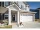 Close up of a beautiful home featuring flower beds and a two-car garage at 10202 Meadow Path Ln, Indianapolis, IN 46239