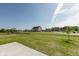 Sprawling backyard with lush green grass, framed by trees and neighboring homes at 1101 Knoll Ct, Greenwood, IN 46143