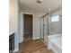 Bright bathroom featuring a glass shower, tub, and an entrance to the large closet at 1101 Knoll Ct, Greenwood, IN 46143