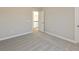 Bedroom with plush neutral carpet and a view into the hallway, featuring neutral paint at 1101 Knoll Ct, Greenwood, IN 46143