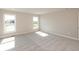 Bright bedroom with two windows offering natural light and neutral carpeting and paint at 1101 Knoll Ct, Greenwood, IN 46143
