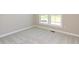 Bedroom with a window, neutral paint, and plush carpeting, viewed from the corner at 1101 Knoll Ct, Greenwood, IN 46143