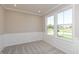 Bedroom featuring neutral walls, wall panelling, and large windows at 1101 Knoll Ct, Greenwood, IN 46143